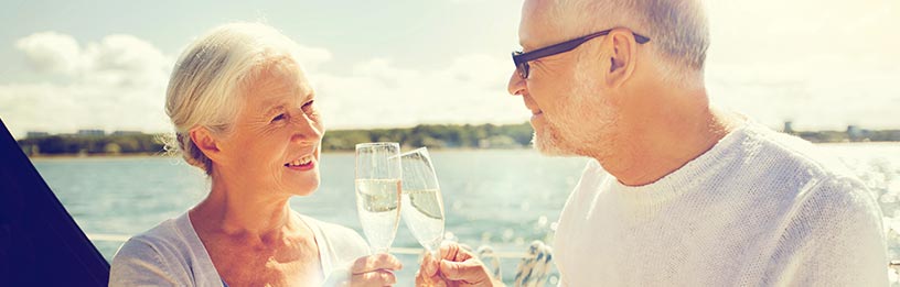Senior couple with champagne on boat