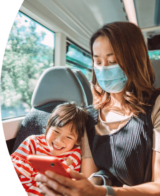 Mother and daughter on bus wearing face masks