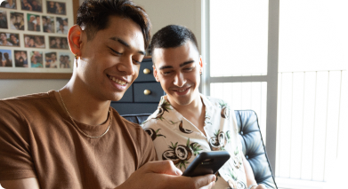 Two men looking at a mobile phone