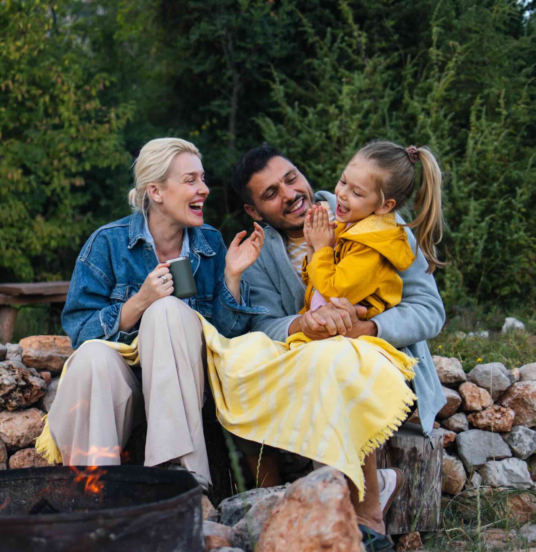 Family enjoying an outdoor fireplace