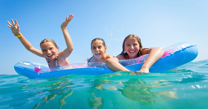 happy kids swimming in ocean